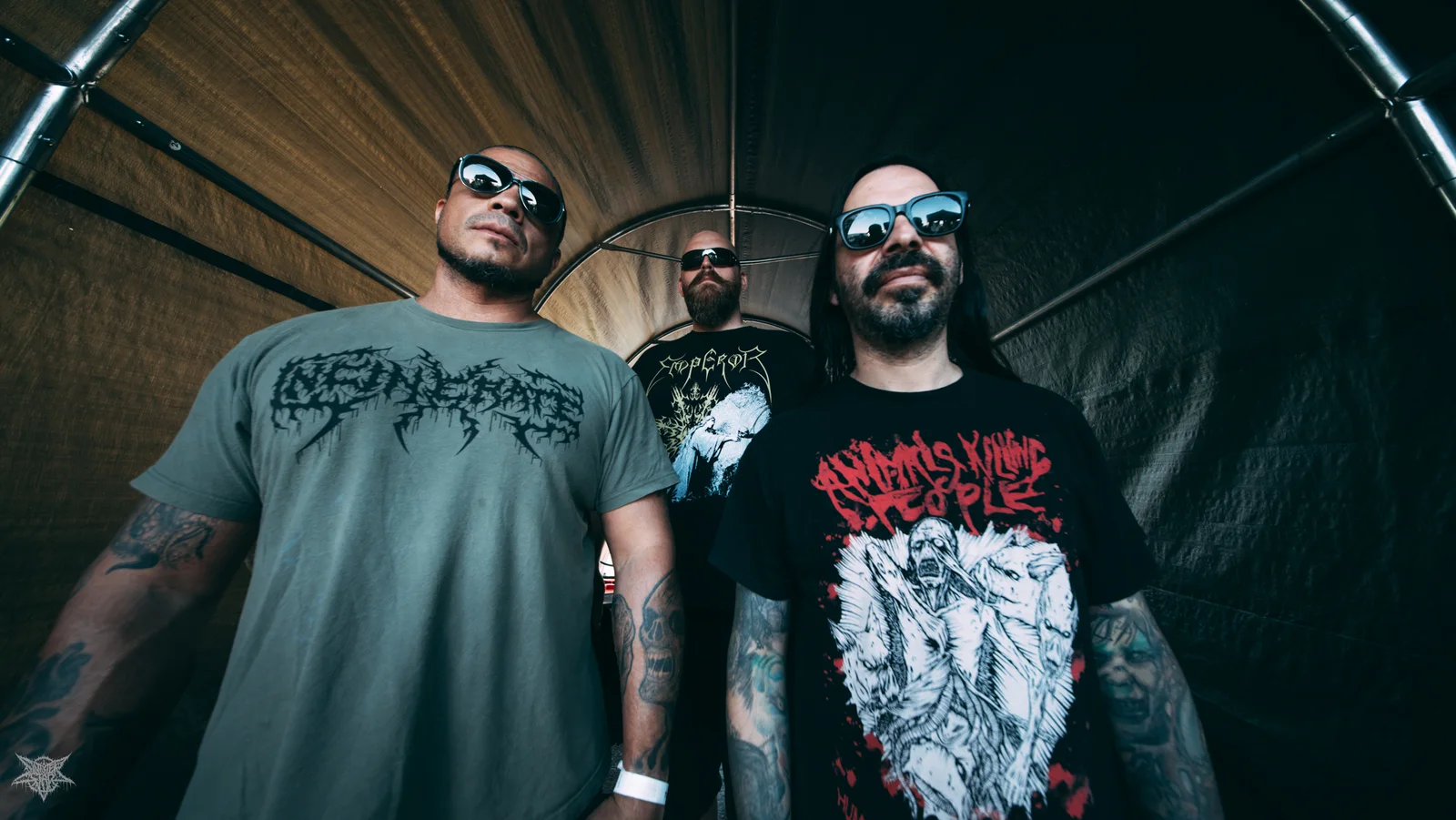 The three members of Extremely Rotten standing together inside a trailer